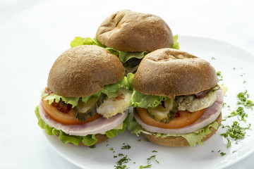 Three sandwich on the plate.