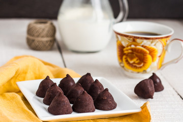 truffle chocolates with a cup of coffee and cream