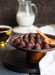 Candy chocolate truffles, cream jug and a cup of coffee