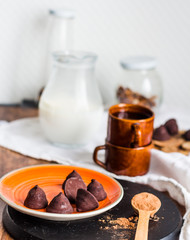 chocolate truffles, cocoa powder in a wooden spoon