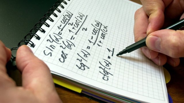 A man writes on paper