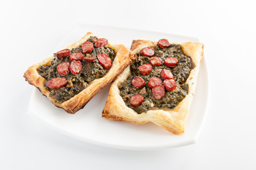spinach topped with sausage