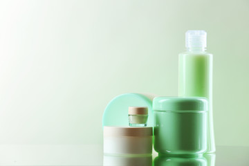 Cosmetic bottles on light background