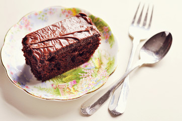 A chocolate cake on a porcelain saucer
