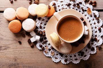 Gentle colorful macaroons and  coffee in mug