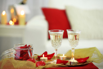 Champagne glasses and rose petals for celebrating Valentines