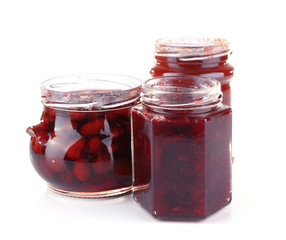 Homemade jars of fruits jam isolated on white background