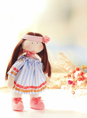 Handmade doll near window close-up