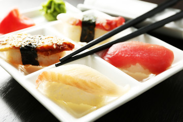 Sushi on plate on wooden table background