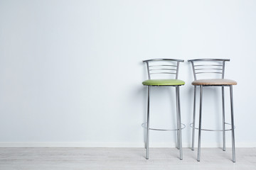 Bar high chairs on white wall background