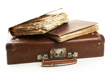 Old wooden suitcase with old books isolated on white
