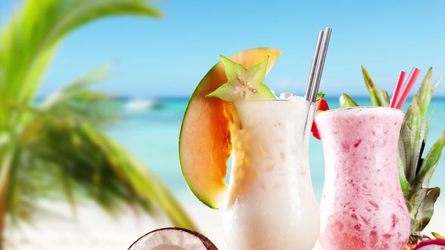 Pan zoom of summer drinks on beach