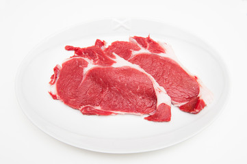 Two raw red sirloin beef on white plate