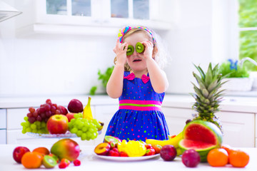 Little girl eating fruit