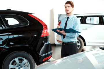 Handsome young man in dealership