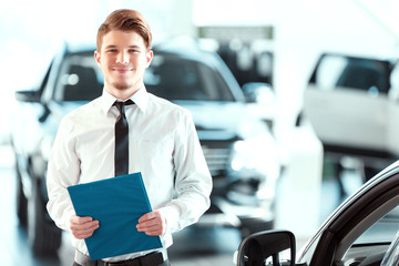 Handsome young man in dealership
