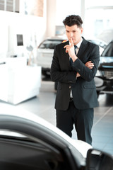 Handsome young man in dealership