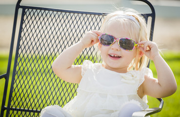 Cute Playful Baby Girl Wearing Sunglasses Outside at Park