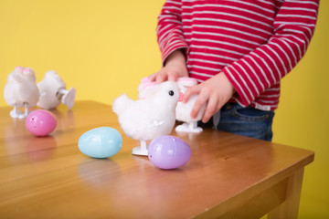 Obraz na płótnie Canvas Child playing with Easter Bunny Toys