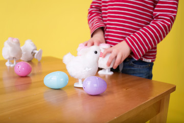 Obraz na płótnie Canvas Child playing with Easter Bunny Toys