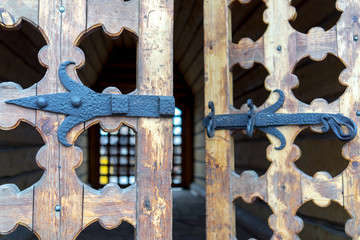 Old wooden door with rusty metal hinge