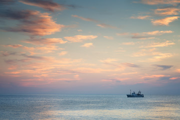 Ship in the sea at sunset