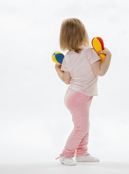 Baby Girl Doing Sport Exercises With Toy Dumbbells