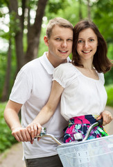 Beautiful happy young couple on bicycle