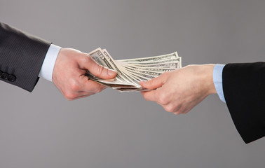 Human hands accepting an offer of money
