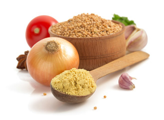 mustard in spoon isolated on white