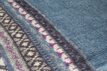 Texture of blue wool fabric with colorful pattern