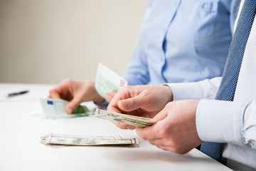 Business people counting banknotes