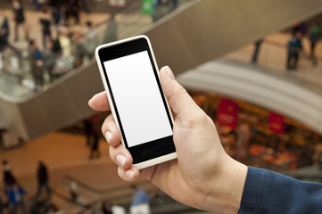 Smartphone with empty screen in woman hand in shopping center