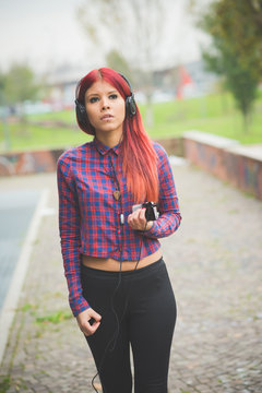 young beautiful red hair venezuelan woman lifestyle listening mu
