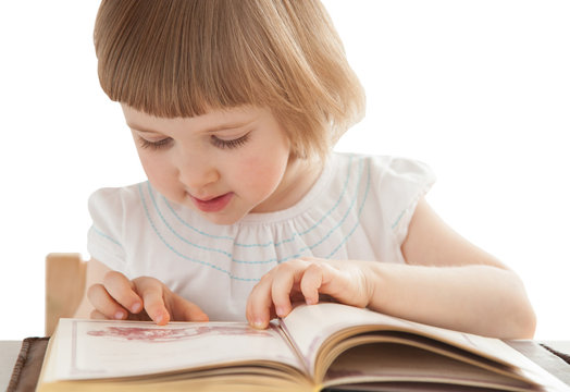 Pretty little girl reading an interesting book
