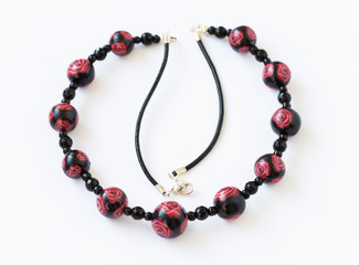 Handmade colorful necklace on white background