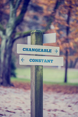Rural signboard with two signs saying - Changeable and Constant