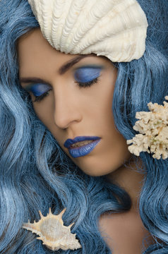 woman with blue hair and seashells