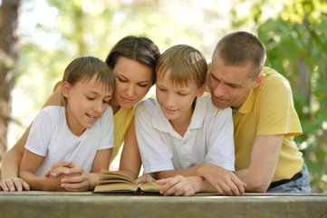 Family reading outdoors