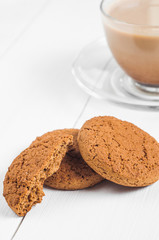 oatmeal cookie with coffee wooden white background
