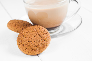 oatmeal cookie with coffee wooden white background