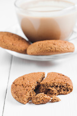 oatmeal cookie with coffee wooden white background