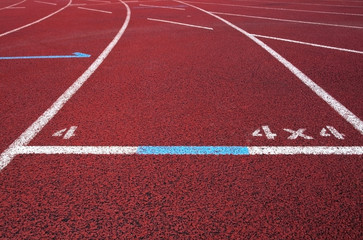 Red running field track with arrows and lines.