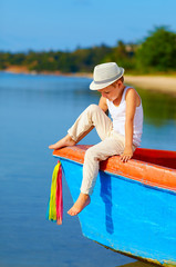 cute kid, boy sitting on the bow of a boat