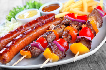 Close up Tasty Kebabs and Sausage on Plate