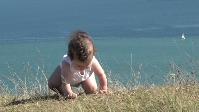 Baby girl crawling outdoors. Baby development concept