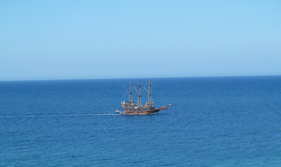 Vintage wooden old ship in blue sea