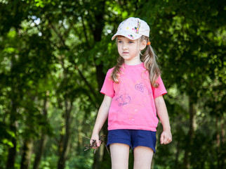 Pretty little girl holding brushwood