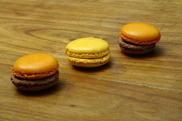 Colored macaroons on wooden table