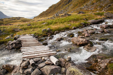Norwegian mountain autumn landscape with bridge near Geiranger